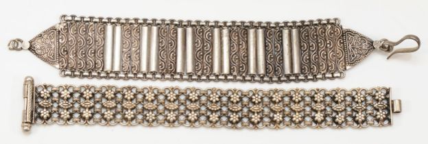 An unmarked silver cluster bracelet, slide clasp, 18cm and another panel link bracelet, 95gm