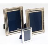 A pair of silver phootograph frames, Sheffield 1994, with embossed decoration, 22 x 17cm and another