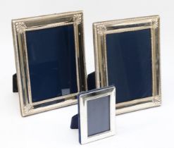 A pair of silver phootograph frames, Sheffield 1994, with embossed decoration, 22 x 17cm and another