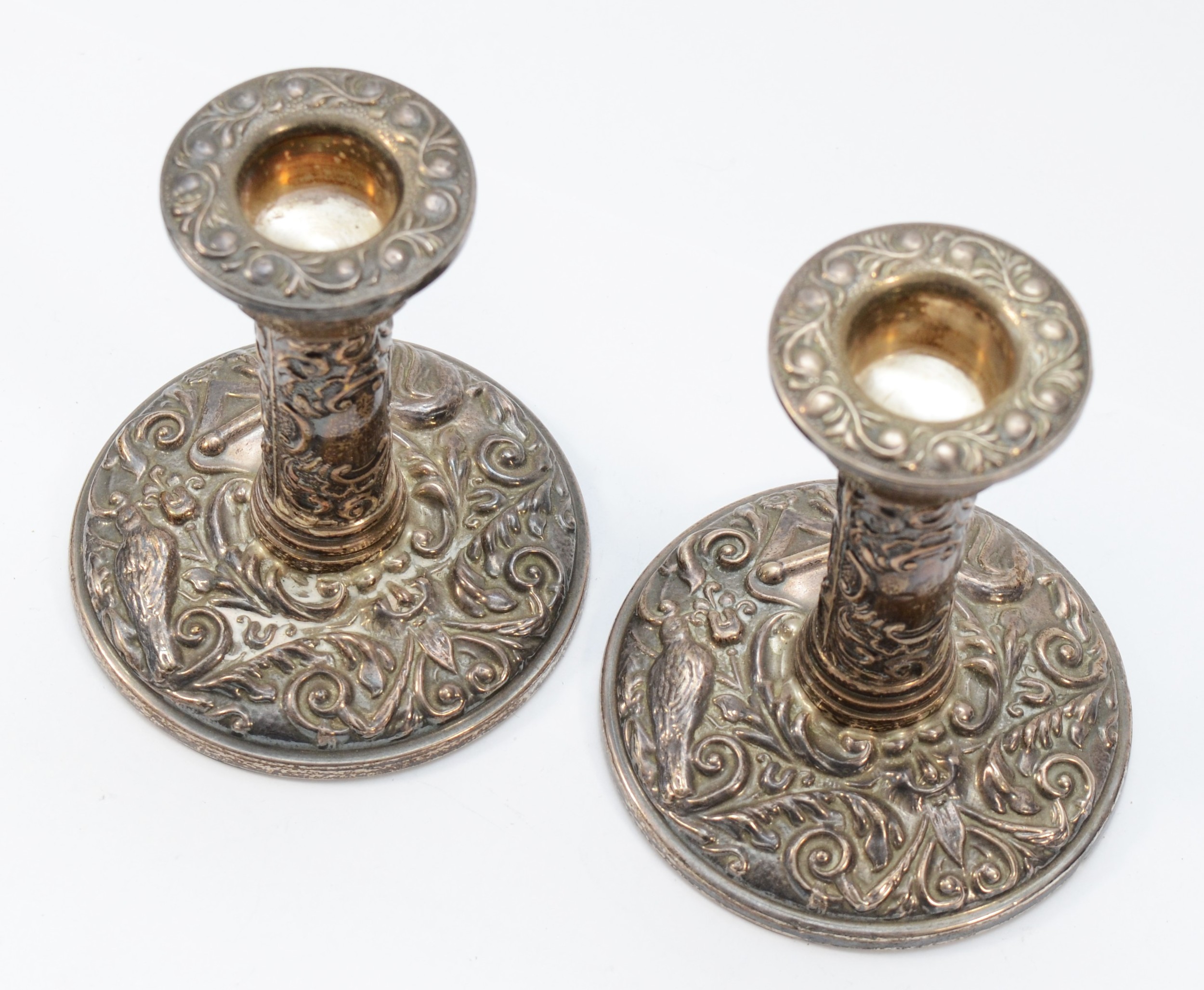 A pair of silver candlesticks, Birmingham 1973, with bird and scroll embossed decoration, 10cm, - Image 2 of 2