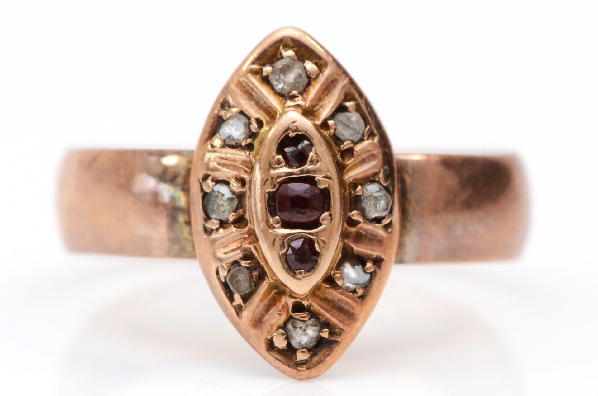 A 9ct rose gold red paste and diamond chip ring, London 1900, Q 1/2, 3.1gm, the shank appears to