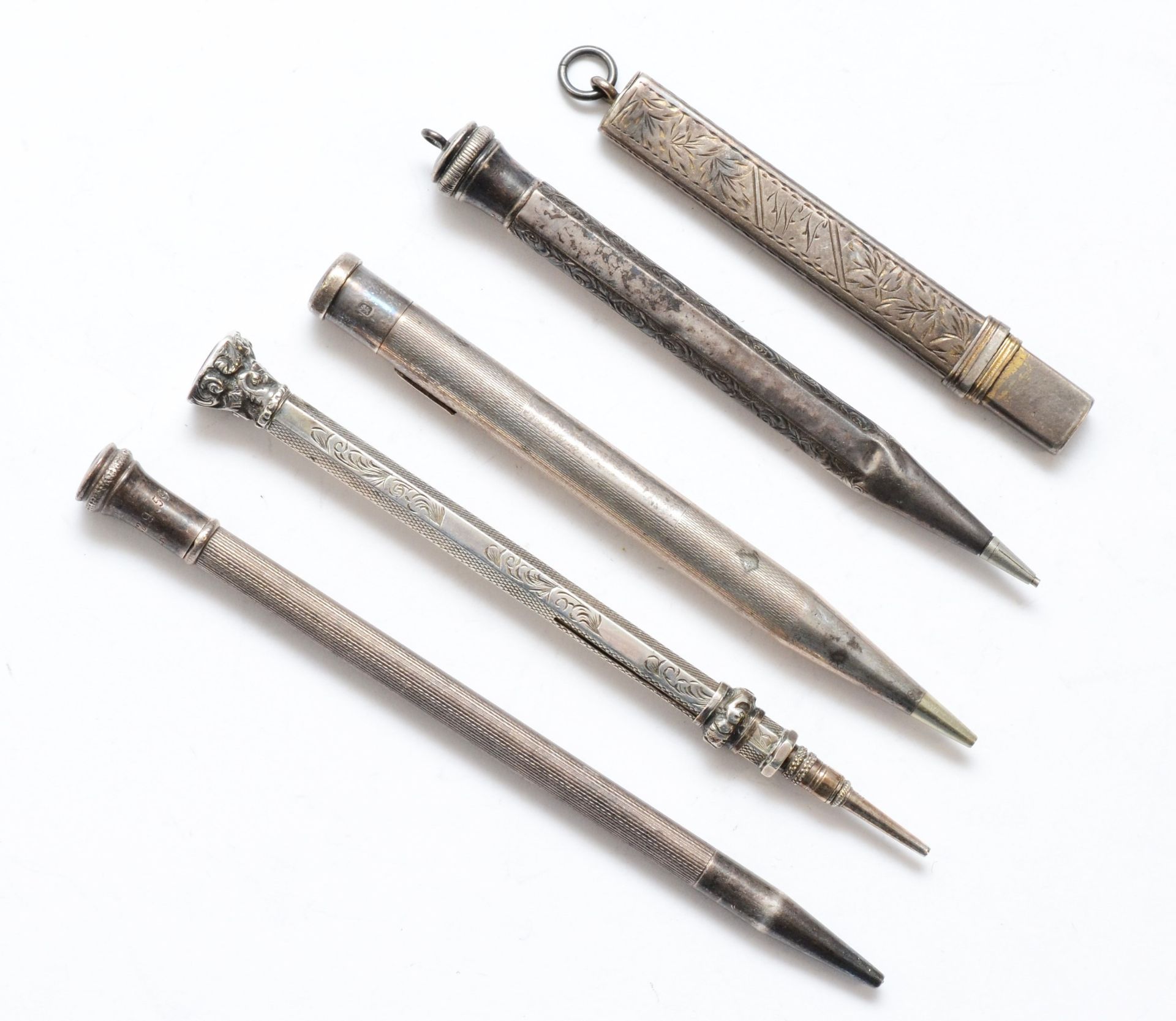A Victorian silver slide action pencil, a silver pencil holder and three Sterling Silver