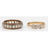 A 9ct gold and CZ three stone ring, M, 1.9gm and a 9ct and silver white stone full eternity ring, N.