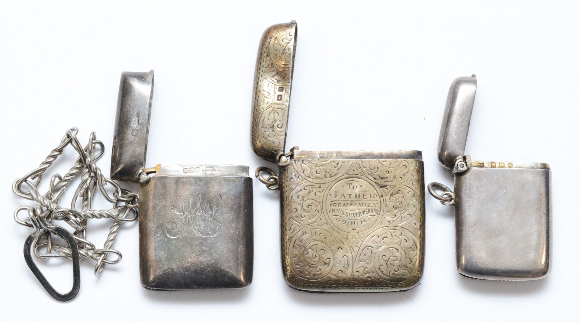 Three silver vesta cases, Birmingham 1906, 1912 and Sheffield 1899, with metal chain attached, - Image 3 of 3