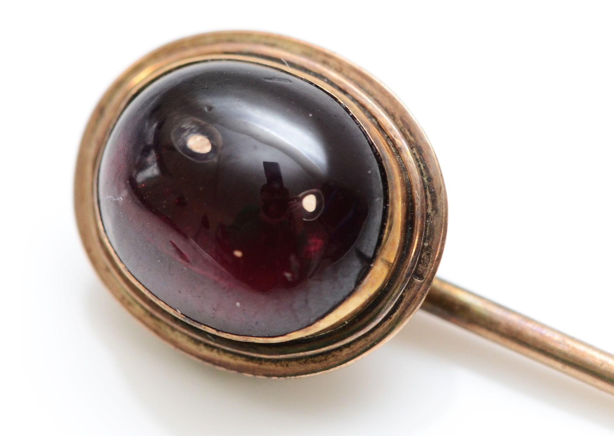 A Victorian gold stickpin set with a cabochon garnet, case - Image 2 of 3