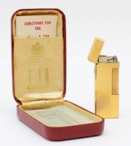 Dunhill, a gold plated Rollagas lighter, case, instructions.
