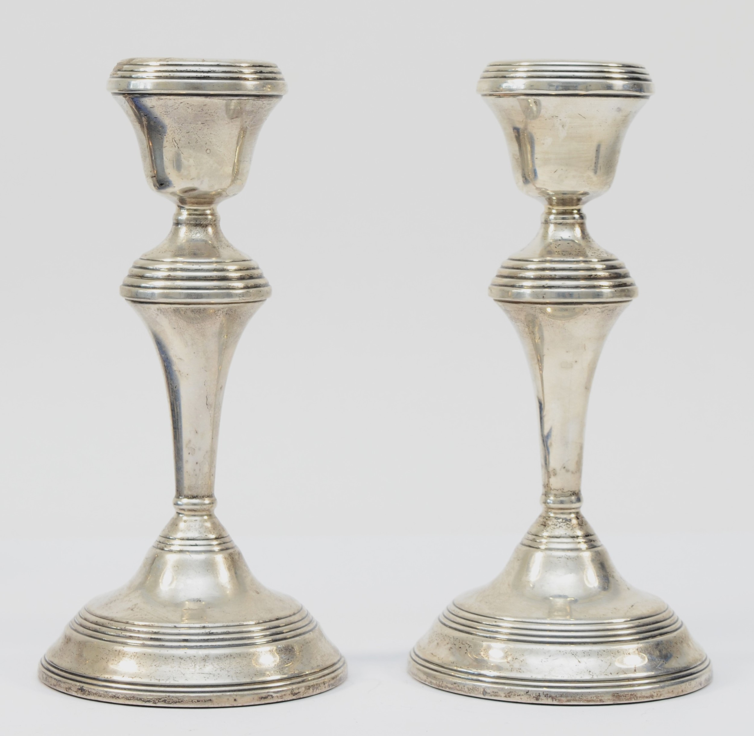 A pair of silver candlesticks, Birmingham 1969, 18cm, loaded.