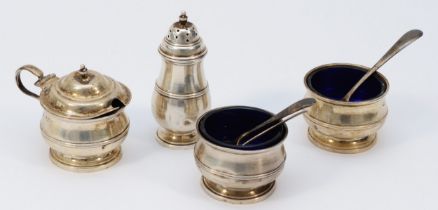 A four piece silver cruet set, Birmingham 1926, blue glass liners, two associated silver spoons,
