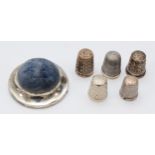 A silver pin cushion, Birmingham 1906, four silver thimbles and a Sterling Silver example