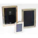 A silver photograph frame, Sheffield 2000, Millennium marks, 21 x 16cm and two other photograph