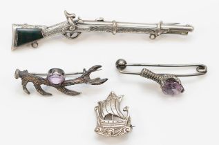A Victorian unmarked silver and bloodstone musket brooch, 9cm, two silver and amethyst animal