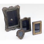 A silver photograph frame, London 1991, with ribbon and swag decoration, 21 x 16cm and three other