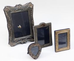 A silver photograph frame, London 1991, with ribbon and swag decoration, 21 x 16cm and three other