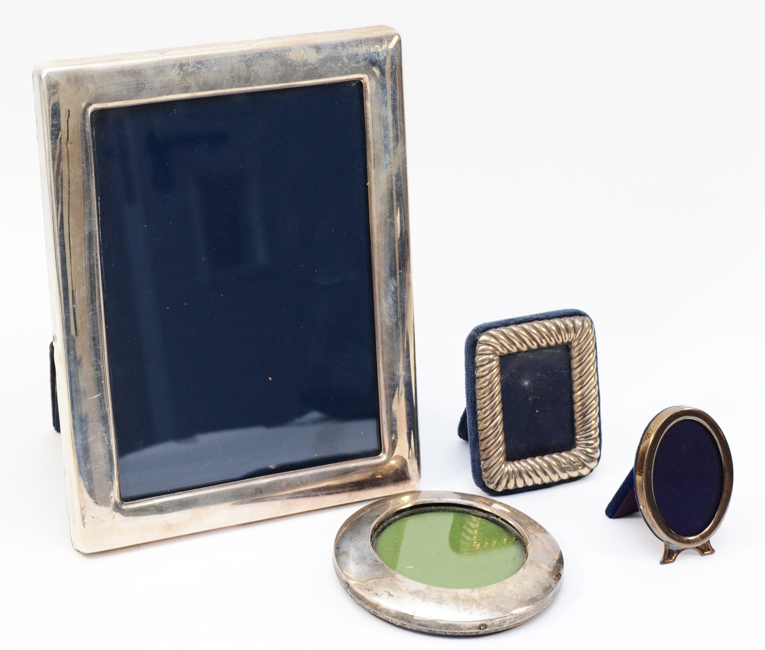A silver photograph frame, Sheffield 1994, 22 x 17cm and three other silver photograph frames.