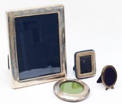 A silver photograph frame, Sheffield 1994, 22 x 17cm and three other silver photograph frames.