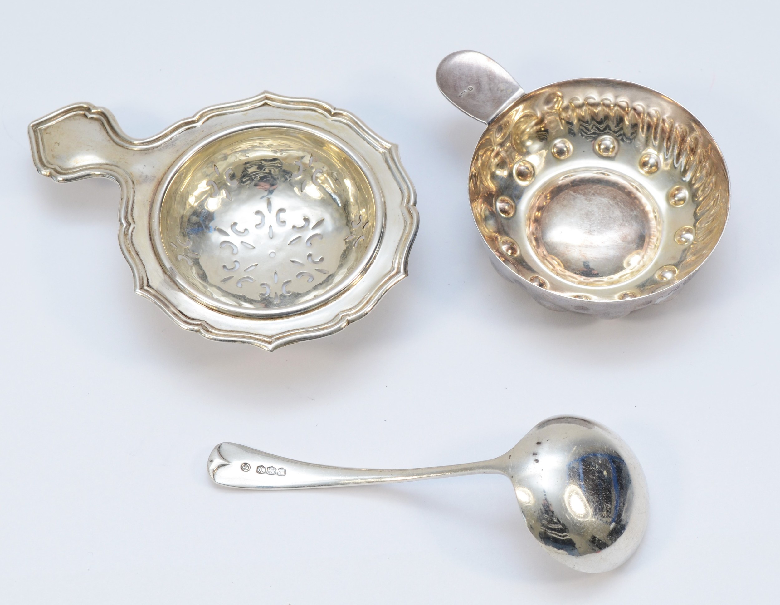 A silver tea strainer, London 1955, a silver sauce ladle, Sheffield 1965, 48gms and an electroplated - Image 2 of 2