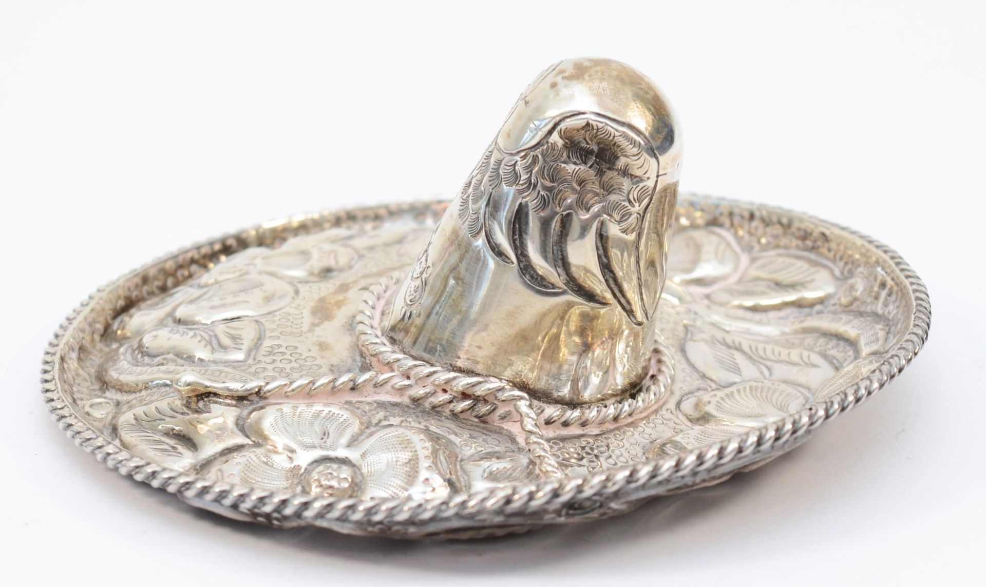 A Mexican Sterling Silver hat, with embossed and chased floral decoration, diameter 13cm, 91gms