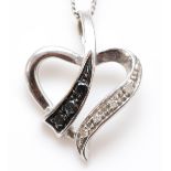 A 9ct white gold black and white diamond heart pendant, chain, 1.9gm