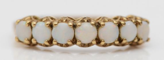 A 9ct gold seven stone opal ring, O, 1.4gm