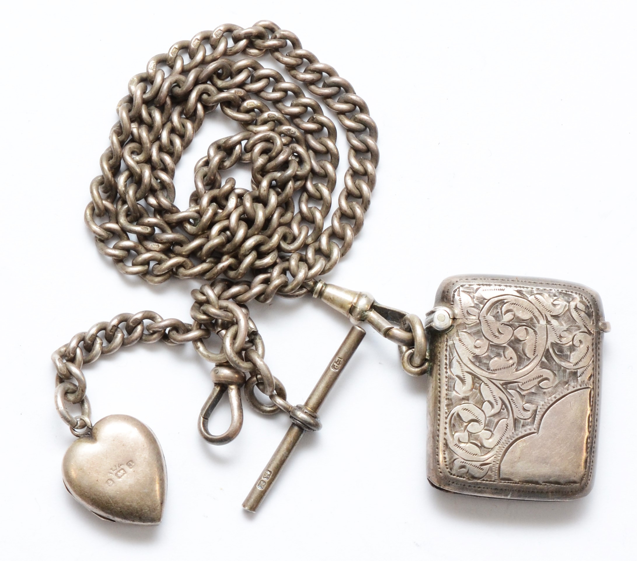 A silver uniform curb link watch chain, Chester 1908, 47cm, with a silver heart shape locket