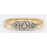 An Art Deco 18ct gold and platinum three stone diamond ring, J 1/2, 2.2gm