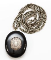 A Victorian oval Jet locket, with metal internal fittings, 49 x 38mm, to an unmarked 66cm silver
