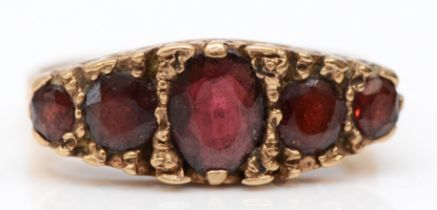 A vintage 9ct gold five stone garnet ring, carved setting, O, 4gm