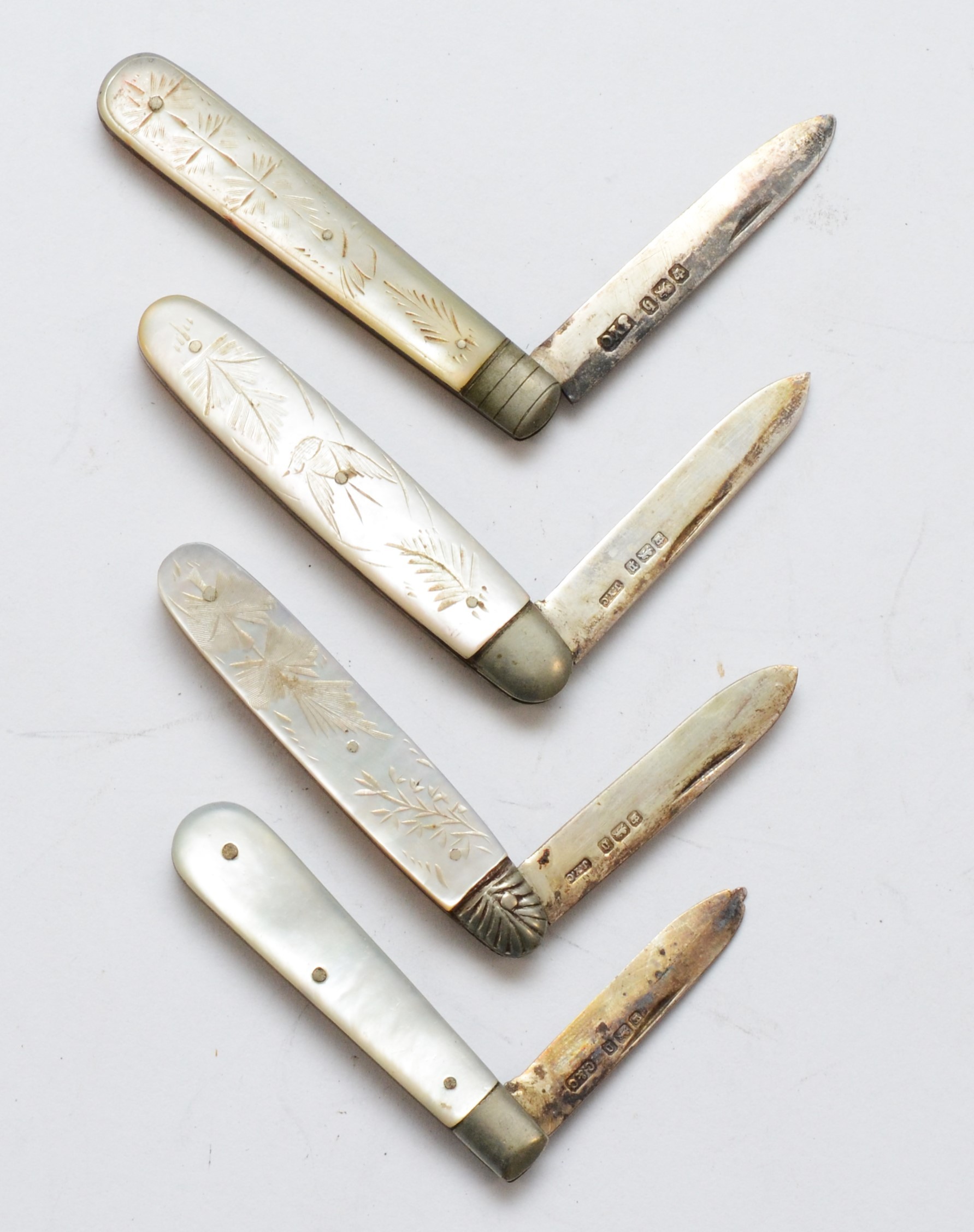 Four silver bladed and mother of pearl fruit knives, various dates