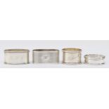 A silver napkin ring, London 1979, initialled R.L.C. and three other silver napkin rings, 89gm