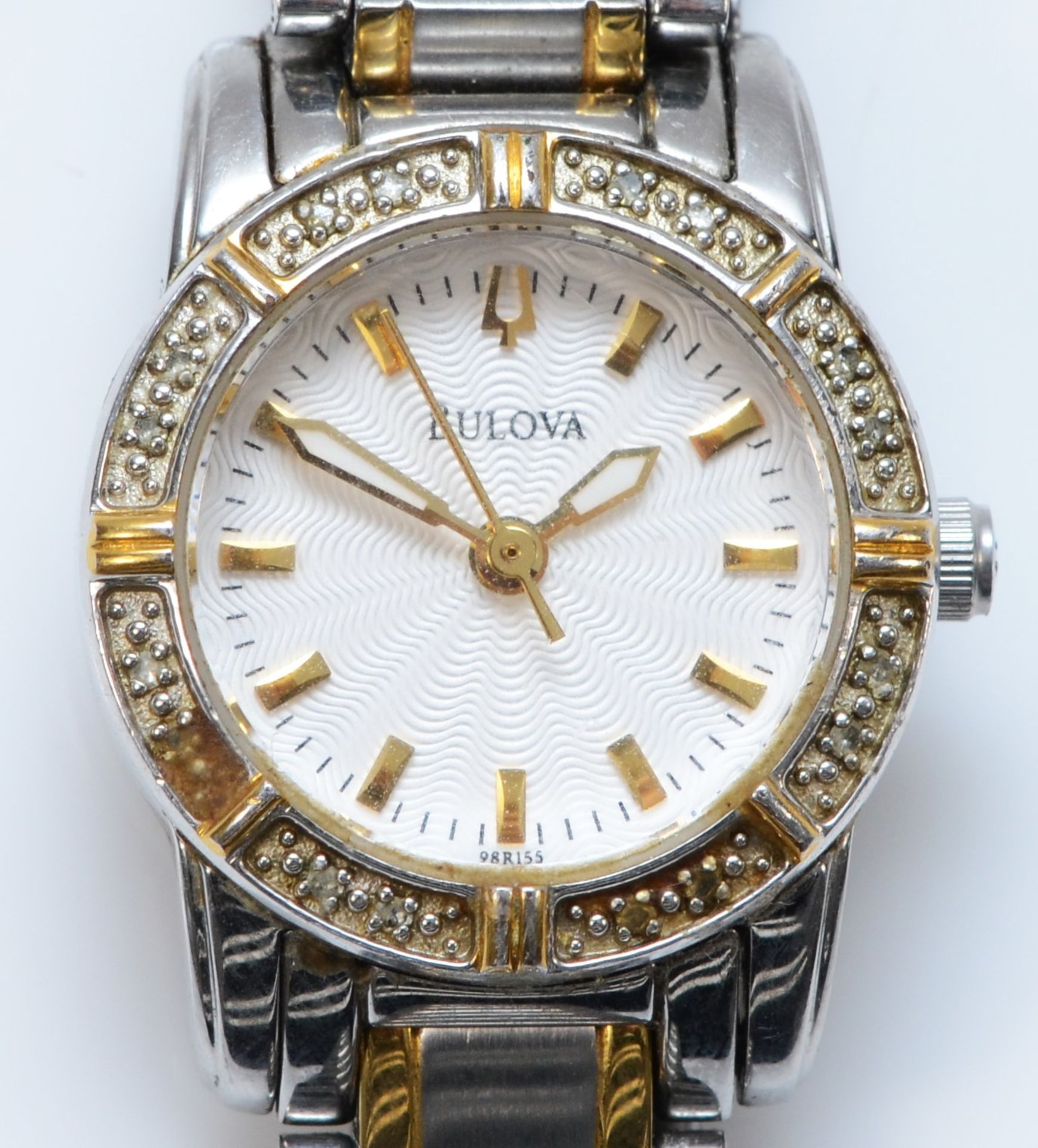 Bulova, a quartz diamond set stainless steel ladies wristwatch, the bezel set with 16 single cut