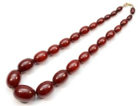 A cherry amber Bakelite graduated beaded necklace, 10 - 25mm beads, 44cm.