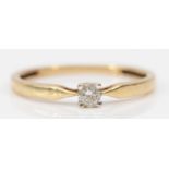 An unmarked 9ct gold and brilliant cut diamond single stone ring, approximately 0.10cts, M 1/2, 1.