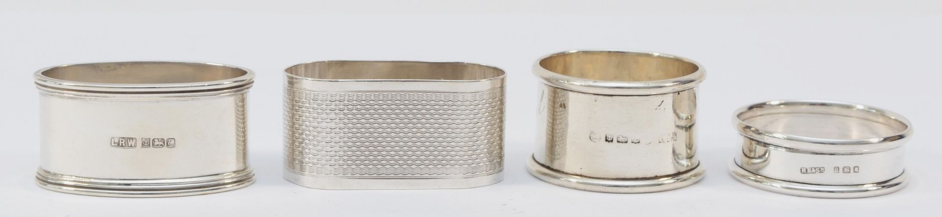 A silver napkin ring, London 1979, initialled R.L.C. and three other silver napkin rings, 89gm - Image 2 of 2
