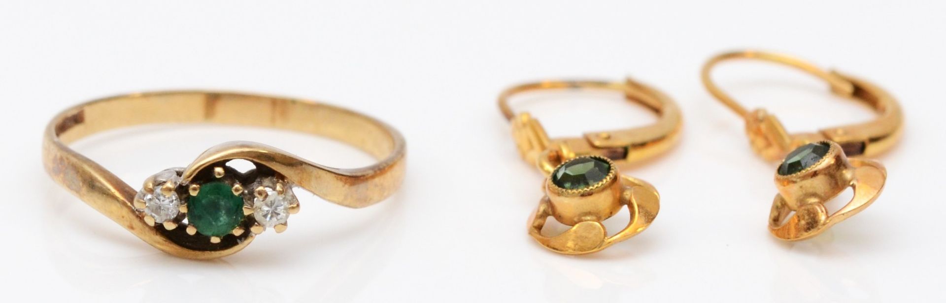 A 9ct gold emerald and diamond three stone ring, P, 1.5gms and a pair of rolled gold ear rings.