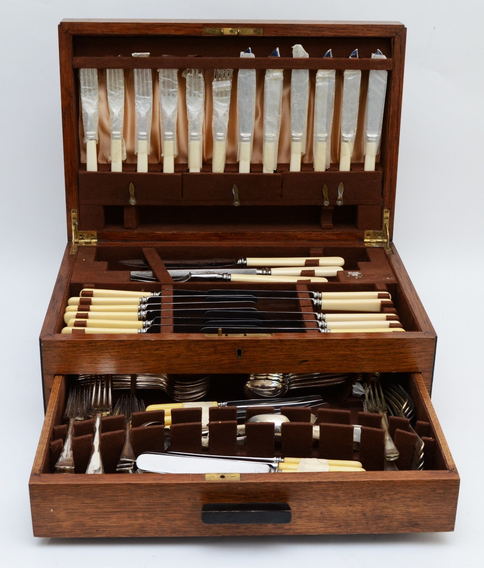 A comprehensive oak cased canteen of cutlery by Sharman D.Neill Belfast, circa mid 20th century.