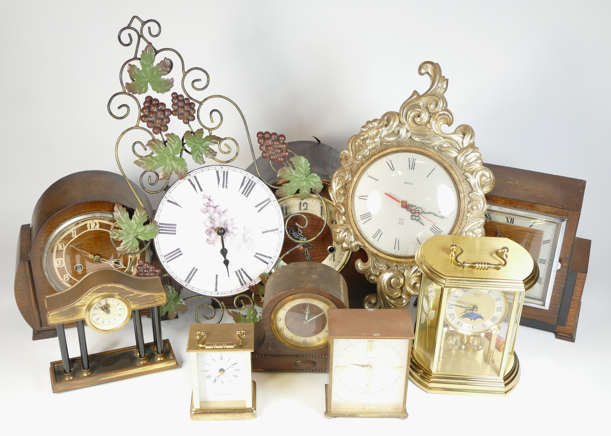 A collection of mid 20th century and later mantel clocks, alarm clocks and barometers in three