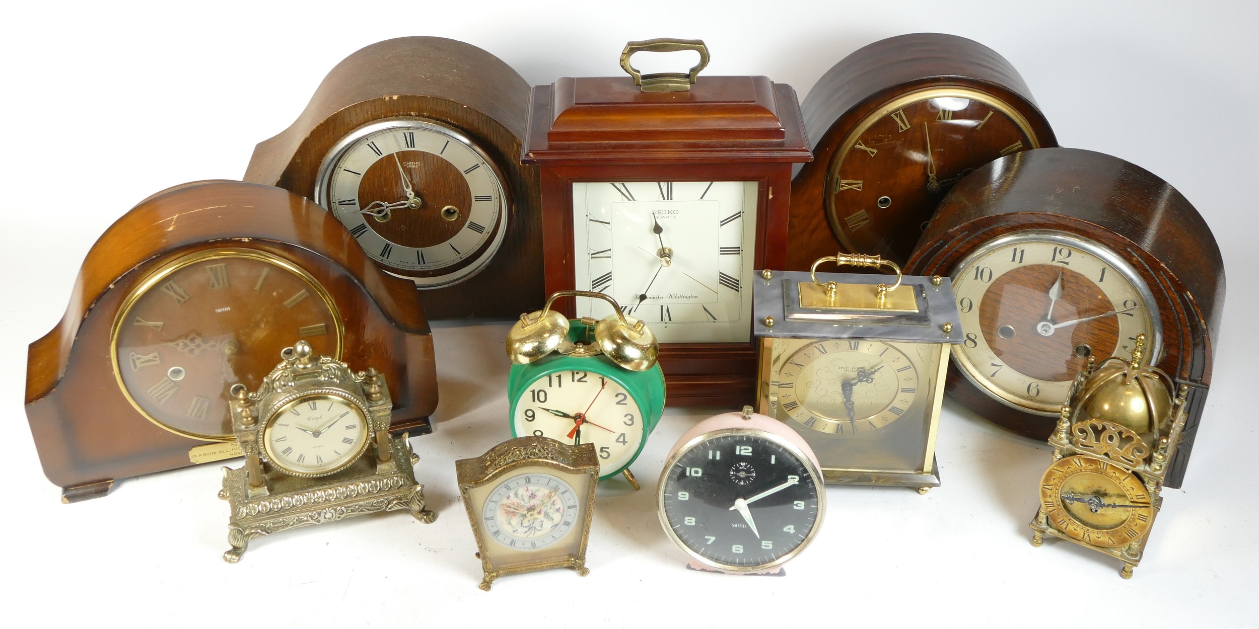 A collection of mid 20th century and later mantel clocks, alarm clocks and barometers in three