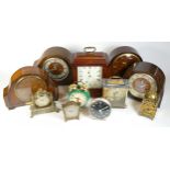 A collection of mid 20th century and later mantel clocks, alarm clocks and barometers in three