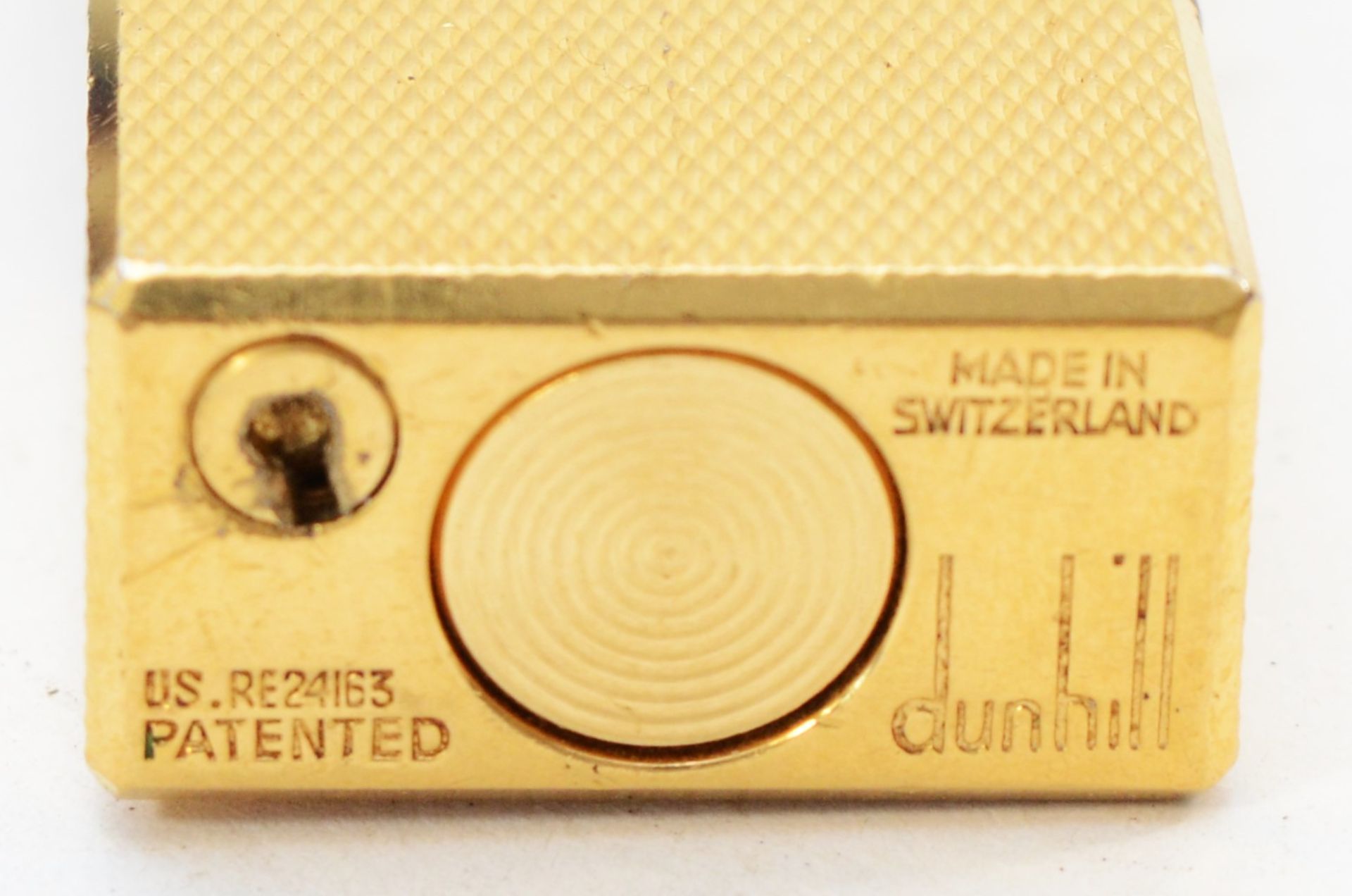 A Dunhill rollagas cigarette lighter, gold plated with engine turned case, together with three Zippo - Image 2 of 2