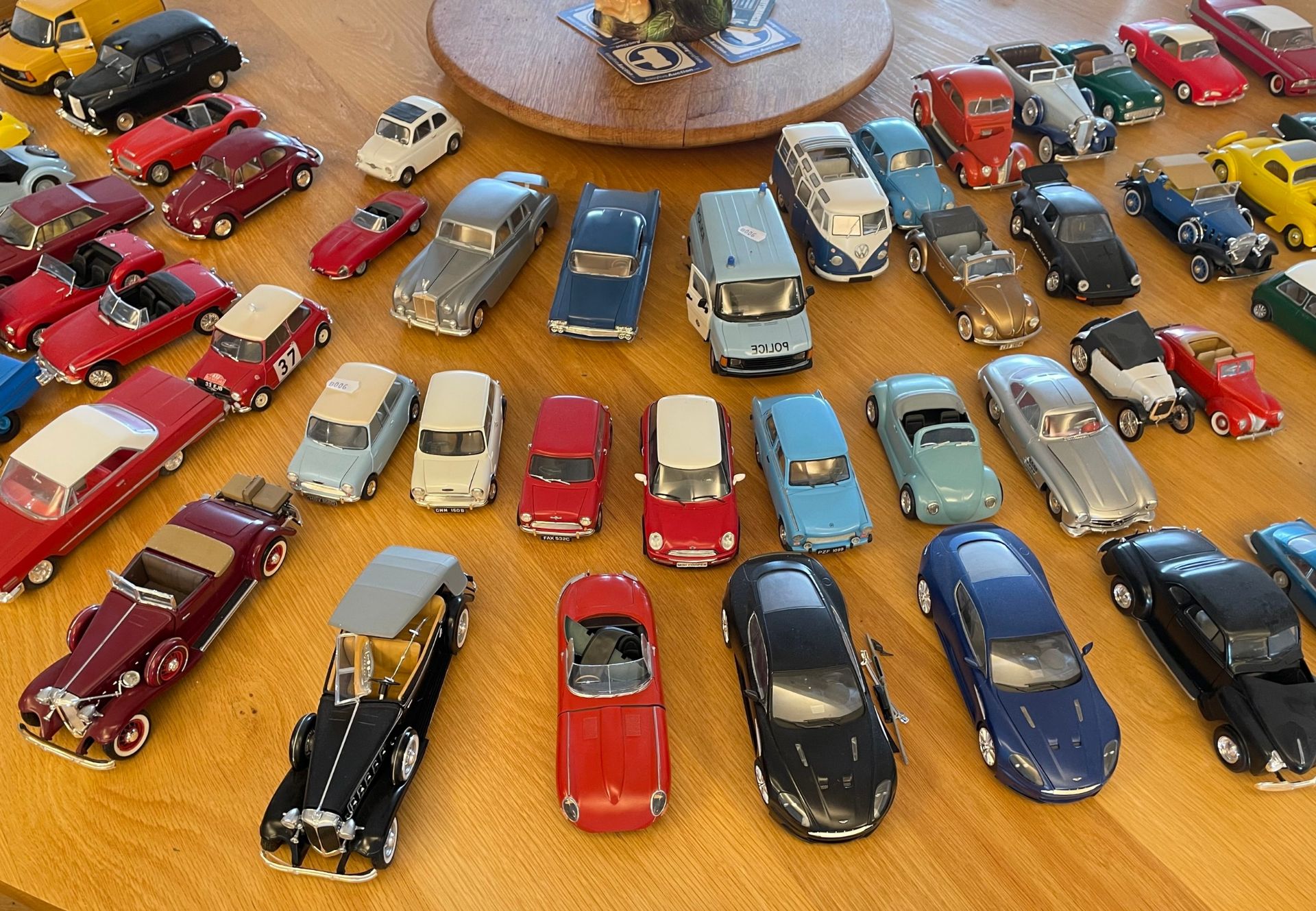 A large quantity of assembled plastic scale model cars to include several VW Beetles, a Mini and a