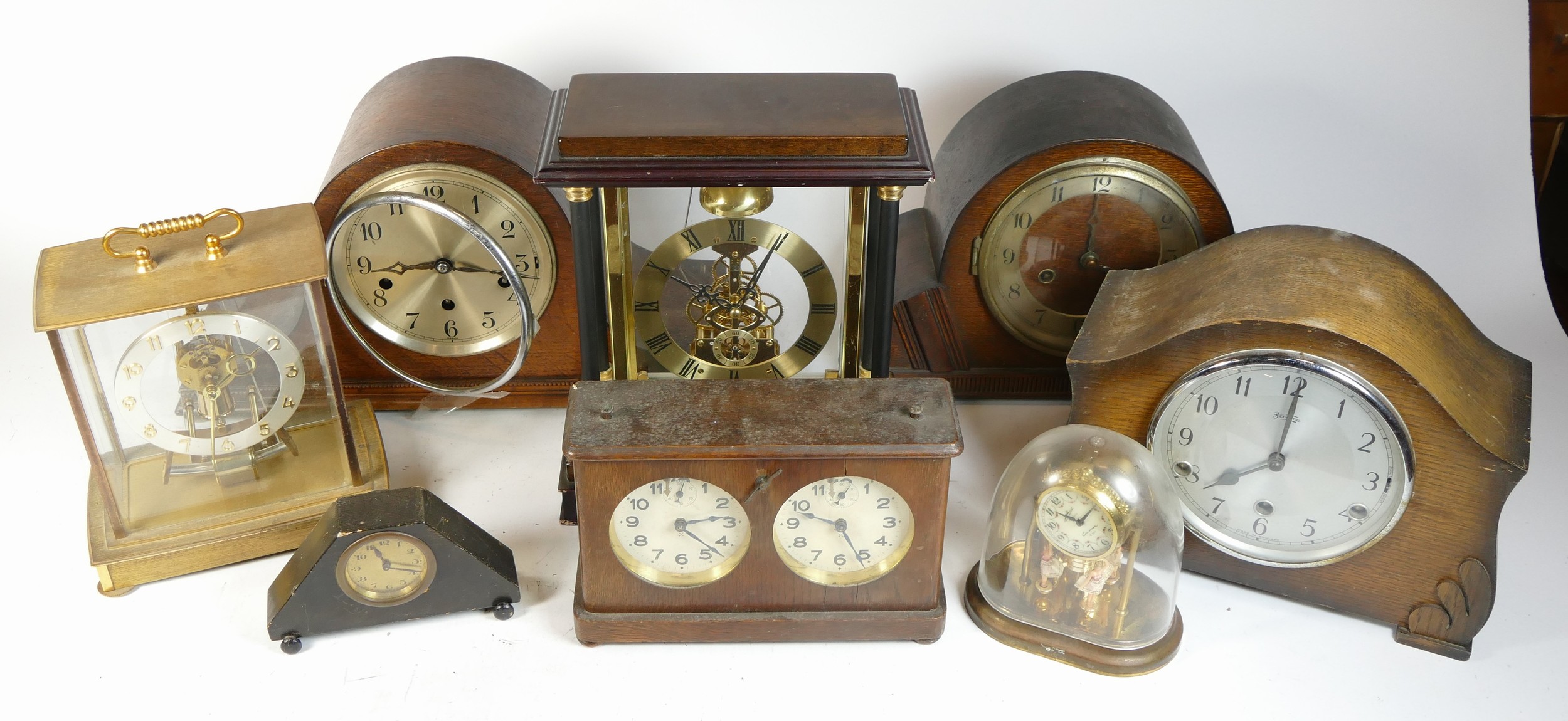 A collection of mid 20th century and later mantel clocks, alarm clocks and barometers in three