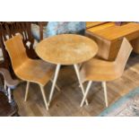 A modern organic three piece bistro set, comprising circular table on four splayed tapered legs,