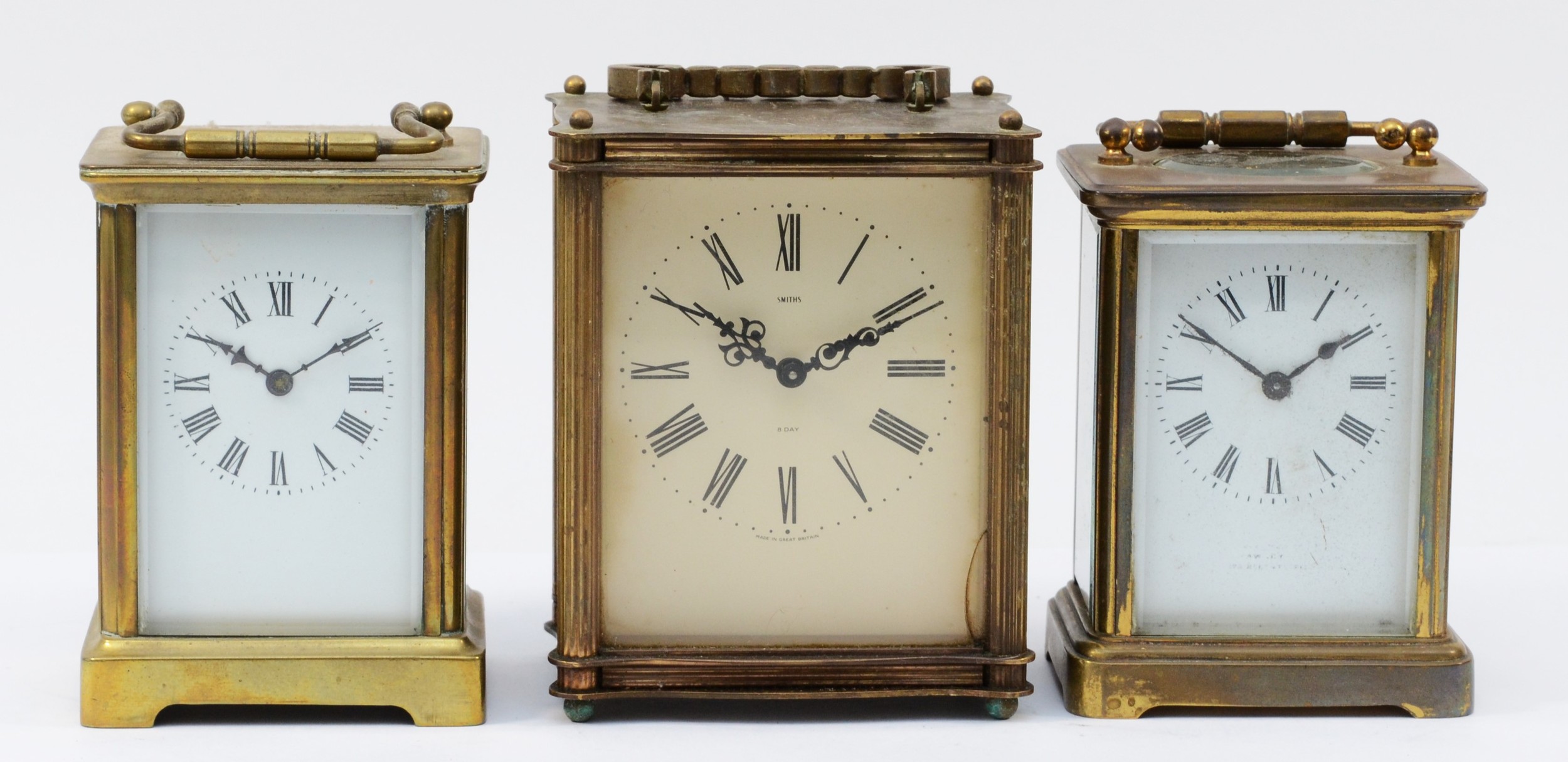 Three mid 20th century carriage clocks, having 8 day movements with floating balance enamelled dials