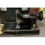 A mid 20th century electric Singer sewing machine, cased, model number 221K