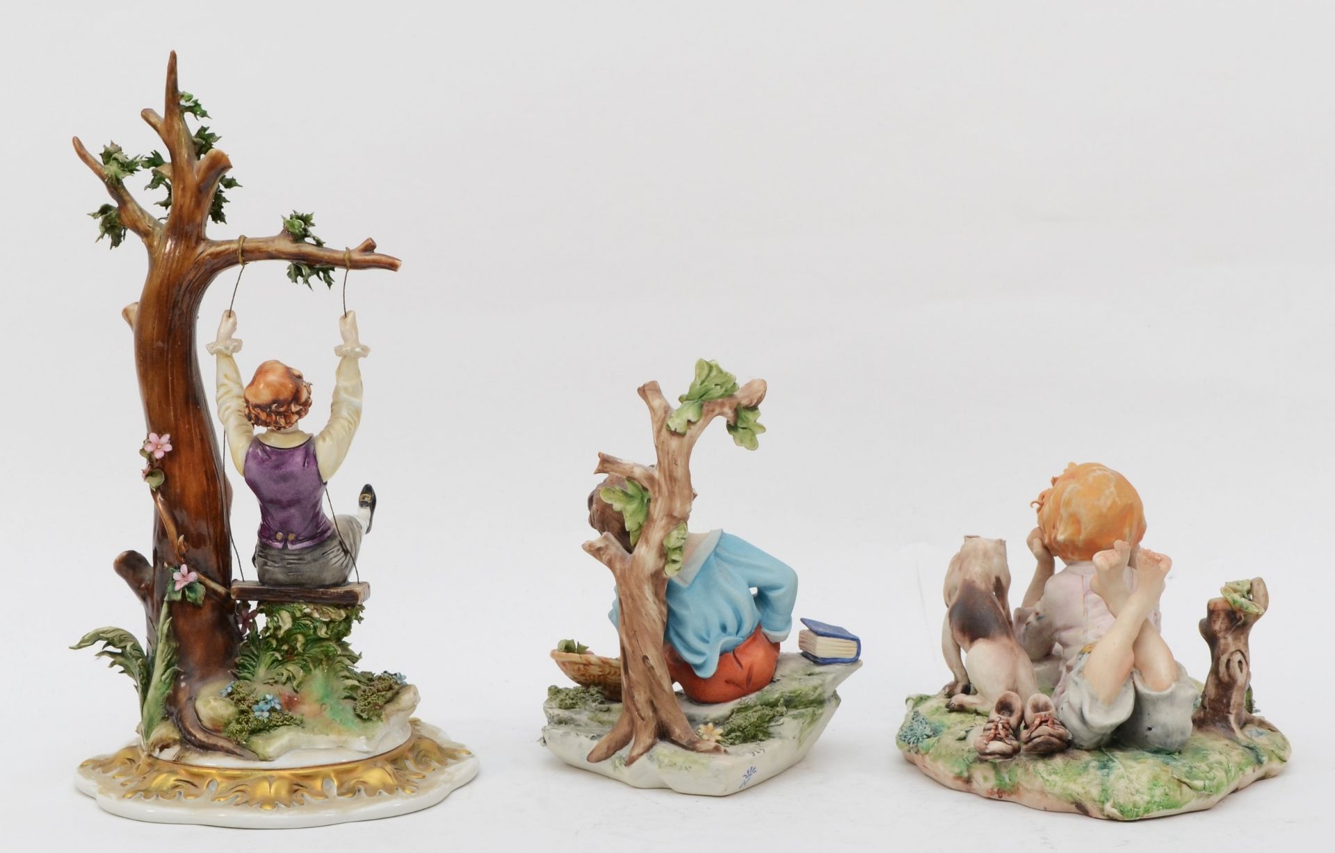 Three 20th century painted Capodimonte porcelain figures, child reading with elbows on her book - Image 2 of 5