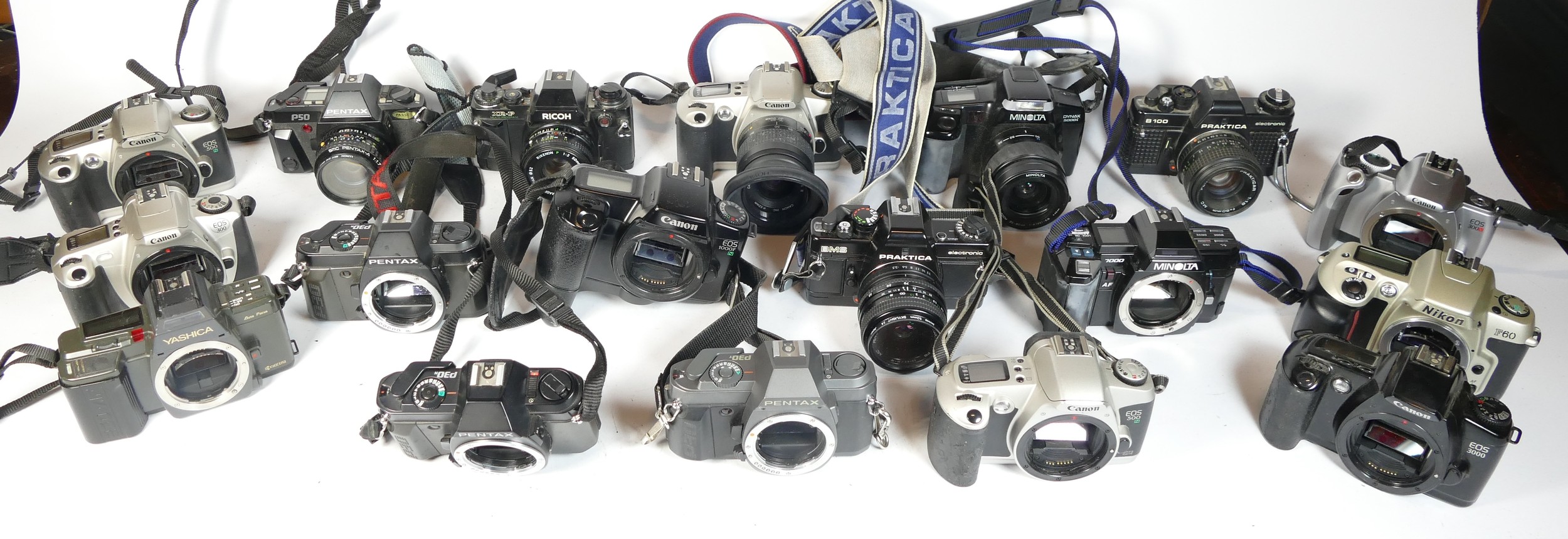 Twenty five SLR vintage film cameras to include a Nikon F80, a Ricoh XR-P, a Canon EOS 300 and a