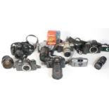 Six SLR vintage film cameras to include a Pentax MZ-50, a Canon EOS 300, a Minolta 500si and a Canon