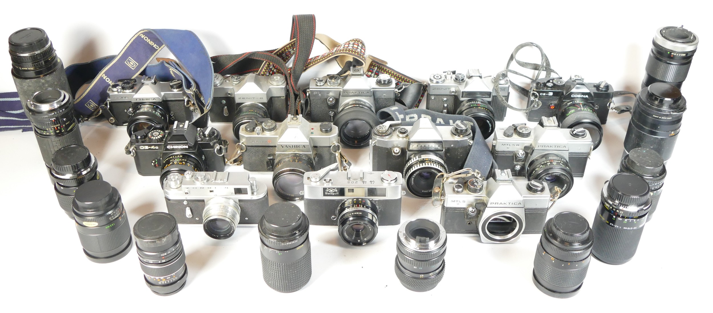 Twelve SLR vintage film cameras to include a Zenit B, a Praktica MTL5B, a Zenit EM and a Yashica