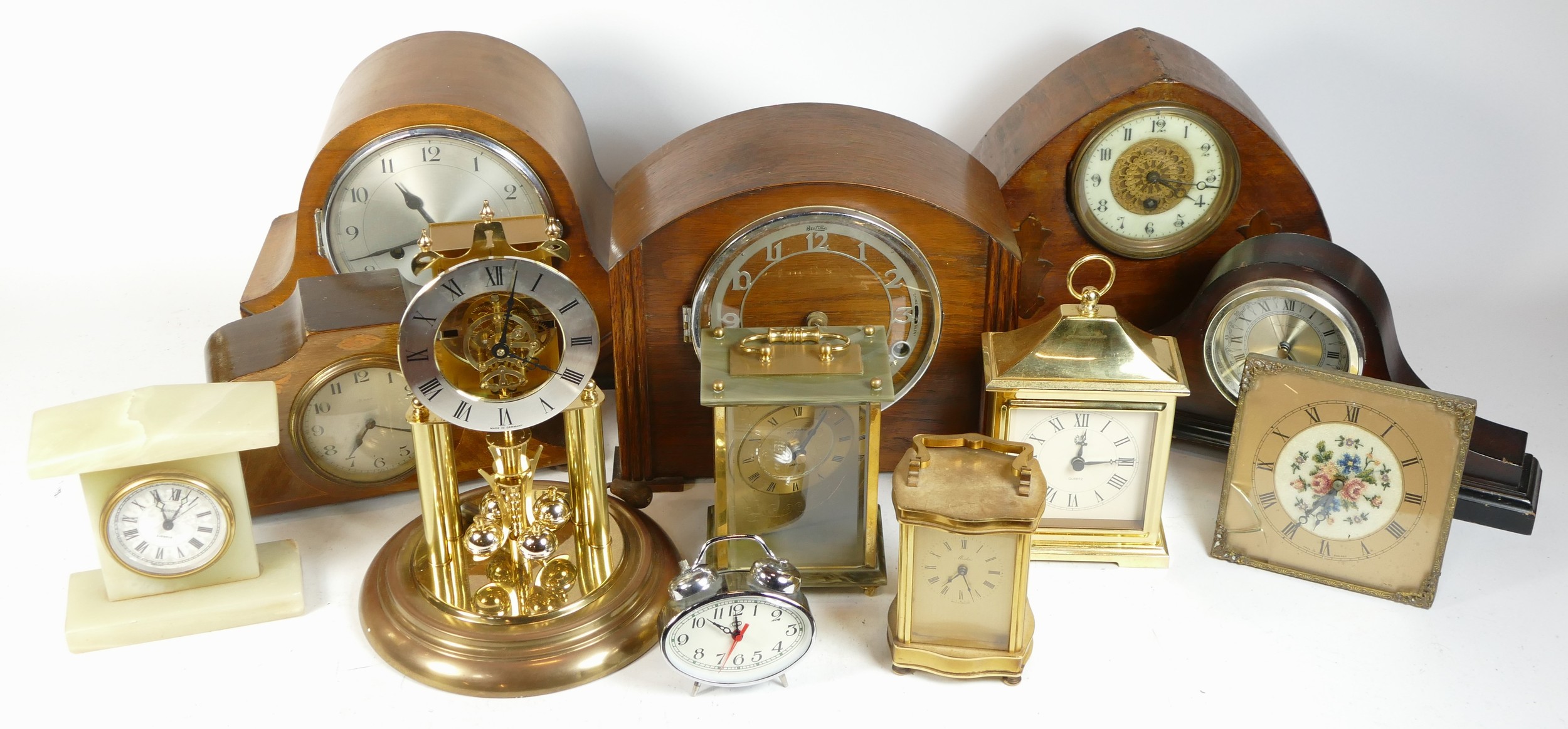 A collection of mid 20th century and later mantel clocks, alarm clocks and barometers in three