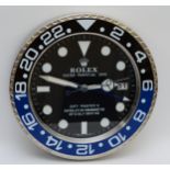 A 'Rolex' style advertising wall clock, black dial reads 'Rolex Oyster Perpetual Date GMT-Master